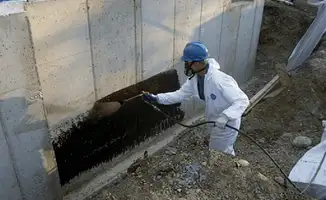 Professional waterproofing the exterior walls of the basement in Naperville, IL