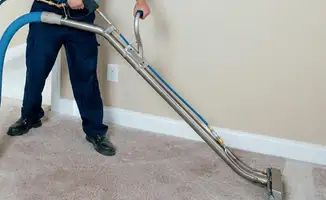 Professional operating a liquid removal machine on a carpeted floor in Naperville, IL